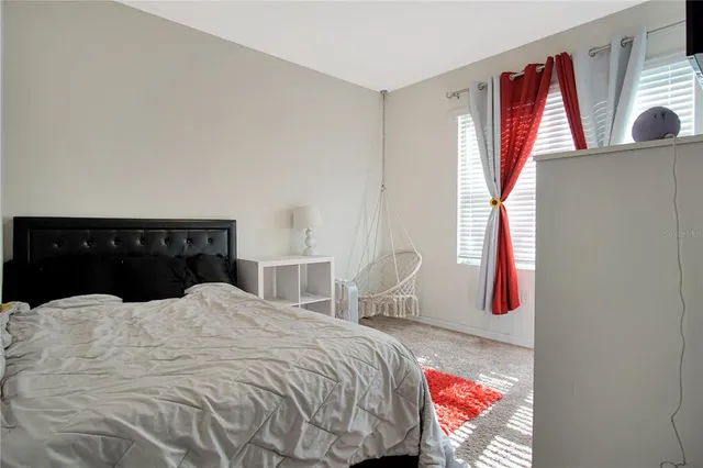 a bedroom with a bed and a tv on the dresser