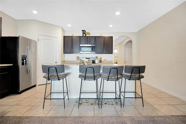 a large kitchen with a table and chairs