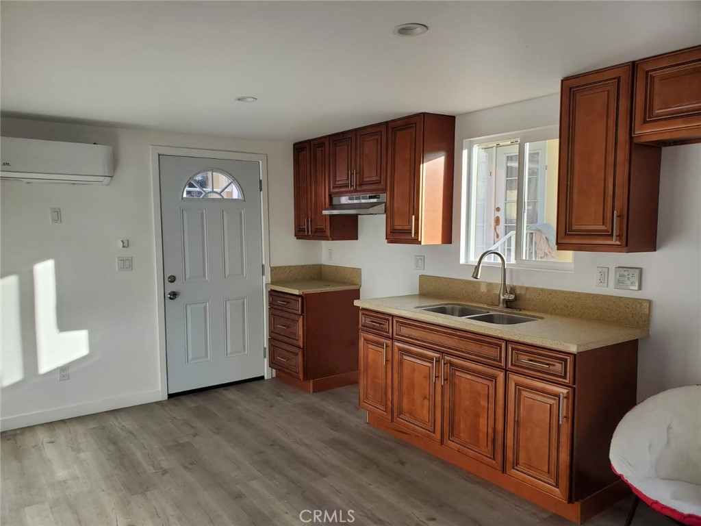 6824 Marcelle Street Paramount, CA 90723 - Photo 29 of 46 a kitchen with granite countertop a sink cabinets and wooden floor