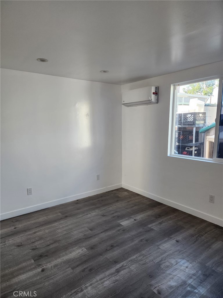 6824 Marcelle Street Paramount, CA 90723 - Photo 35 of 46 a view of an empty room with wooden floor and a window