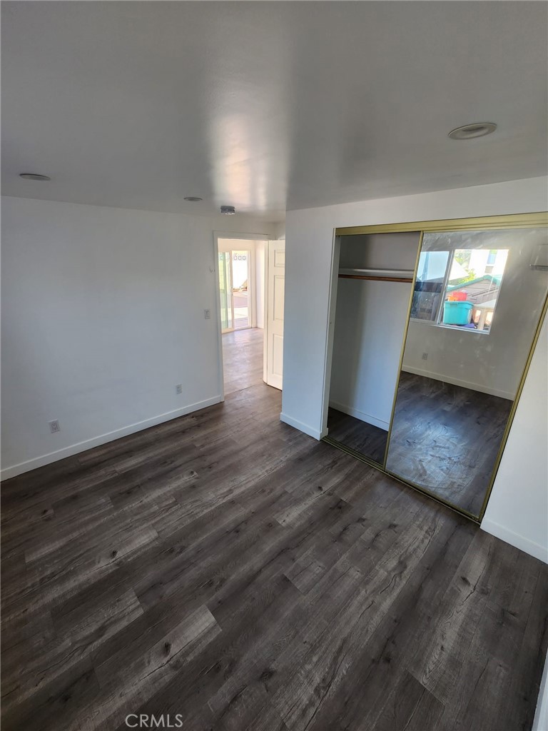 6824 Marcelle Street Paramount, CA 90723 - Photo 36 of 46 a view of empty room with wooden floor and kitchen