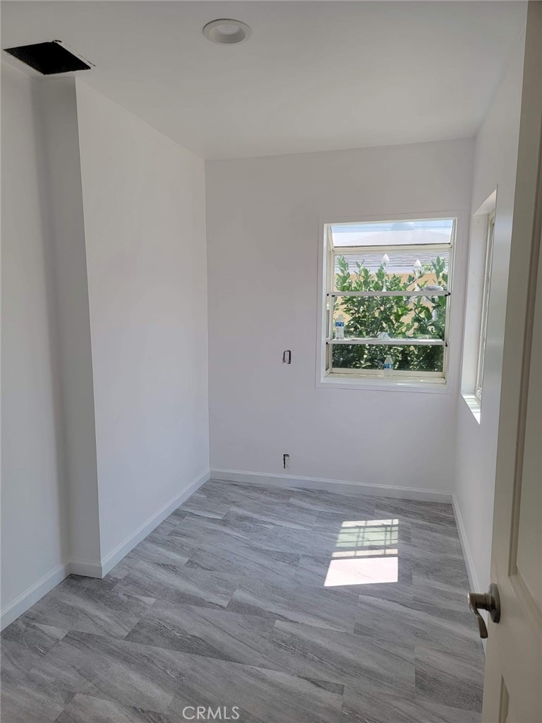 6824 Marcelle Street Paramount, CA 90723 - Photo 37 of 46 an empty room with wooden floor and windows
