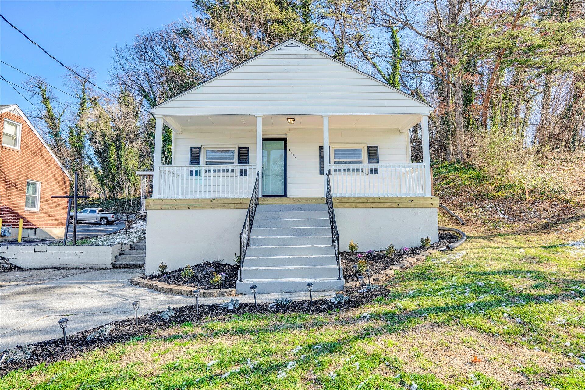 1329 Peters Creek Road Roanoke, VA 24017 - Photo 1 of 27 a front view of house with yard and trees in the background