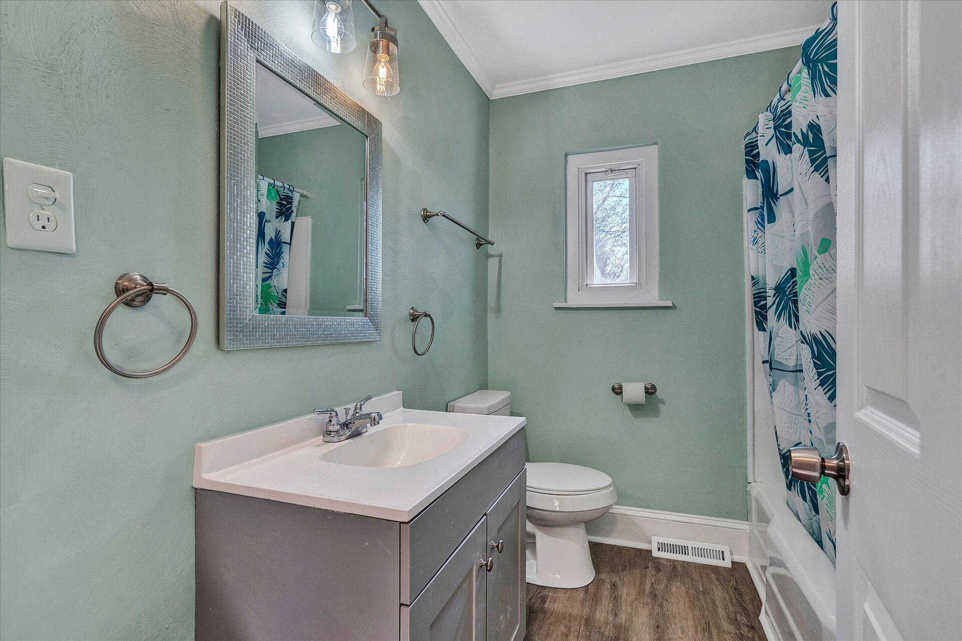 1329 Peters Creek Road Roanoke, VA 24017 - Photo 15 of 27 a bathroom with a sink toilet and shower