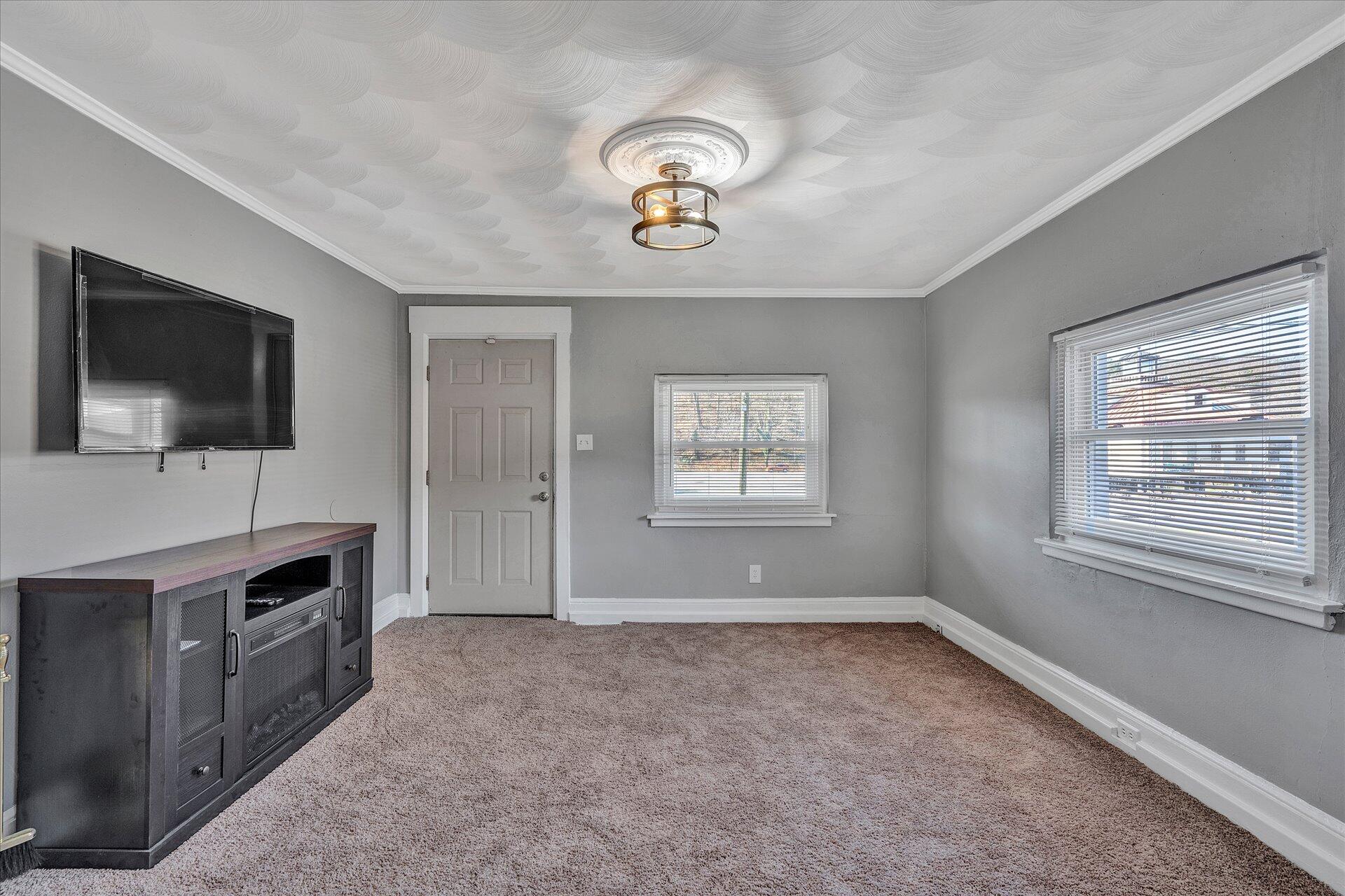 1329 Peters Creek Road Roanoke, VA 24017 - Photo 3 of 27 a view of a livingroom with furniture and a flat screen tv