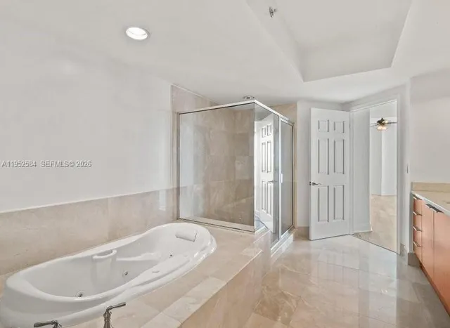 a bathroom with a bathtub and shower