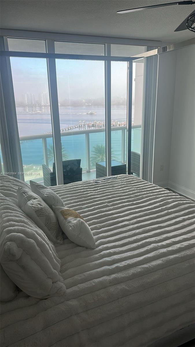 231 Riverside Drive, Unit 708 Daytona Beach, FL 32117 - Photo 9 of 17 a bedroom with a bed and a large window