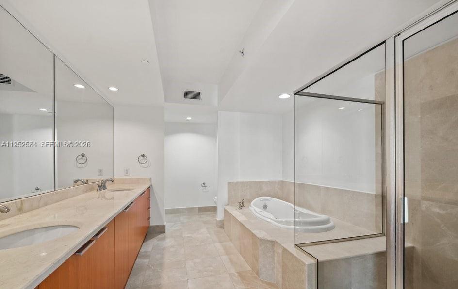 231 Riverside Drive, Unit 708 Daytona Beach, FL 32117 - Photo 10 of 17 a bathroom with a sink a toilet and shower