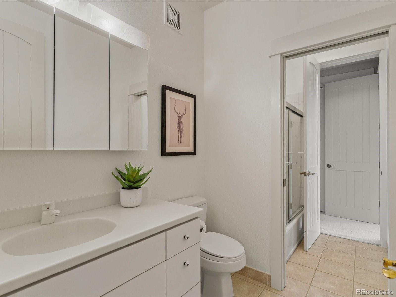 6264 Flagstaff Road Boulder, CO 80302 - Photo 16 of 50 a bathroom with a granite countertop sink toilet and shower