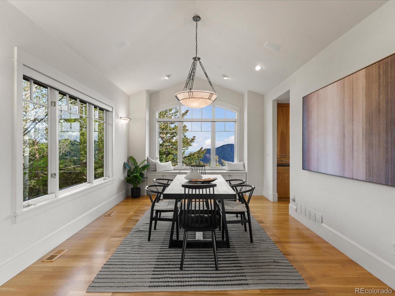 6264 Flagstaff Road Boulder, CO 80302 - Photo 20 of 50 a dining room with furniture a chandelier and wooden floor