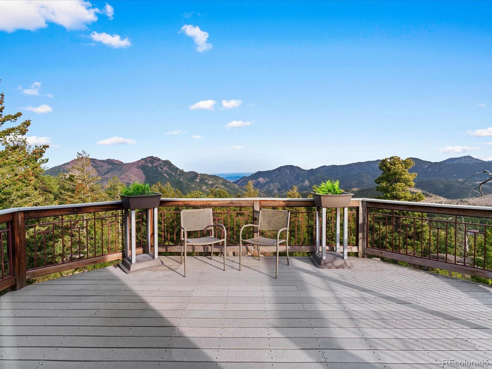 6264 Flagstaff Road Boulder, CO 80302 - Photo 35 of 50 a view of a balcony with chairs and wooden floor