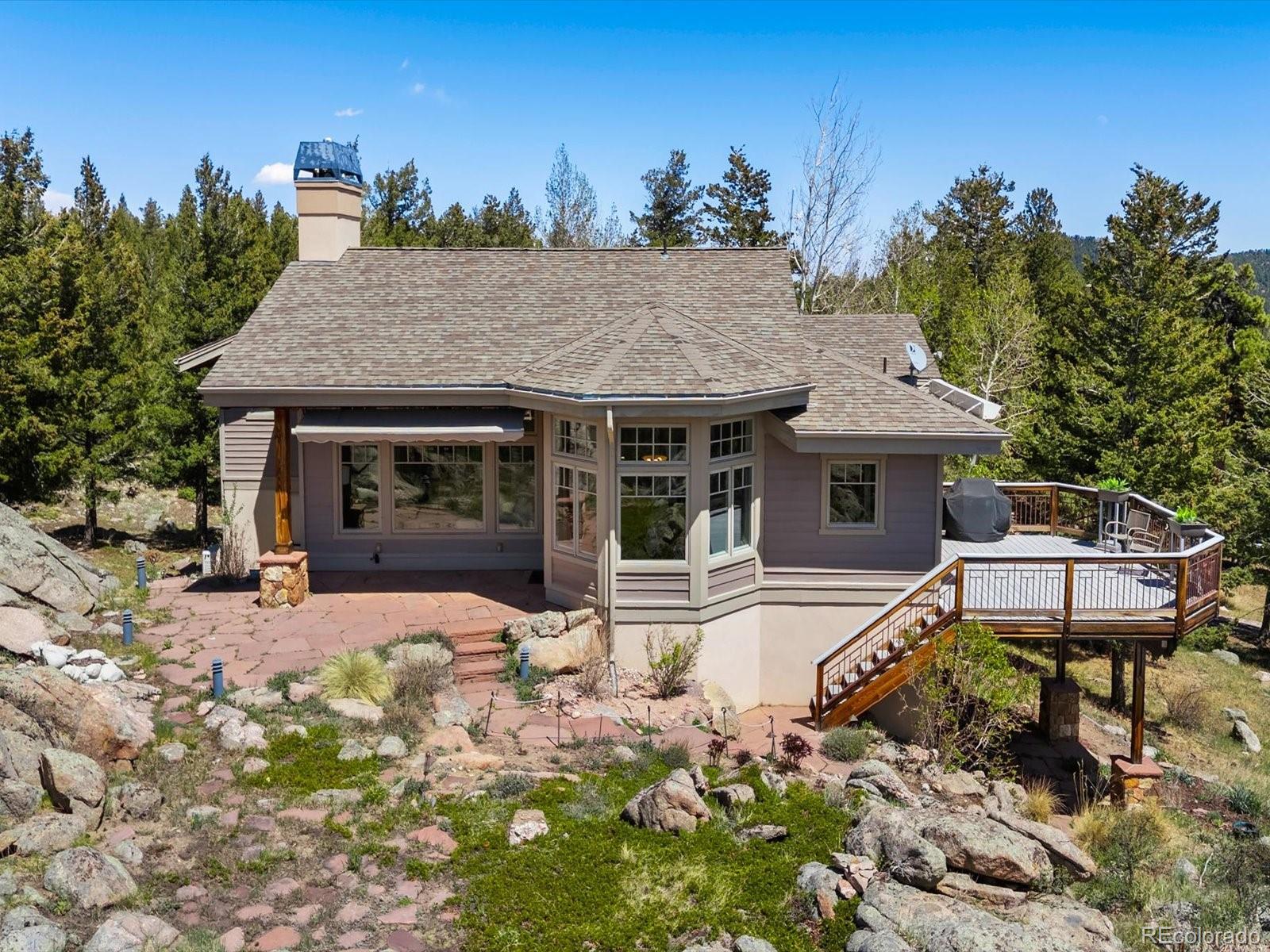 6264 Flagstaff Road Boulder, CO 80302 - Photo 5 of 50 a front view of a house with a garden