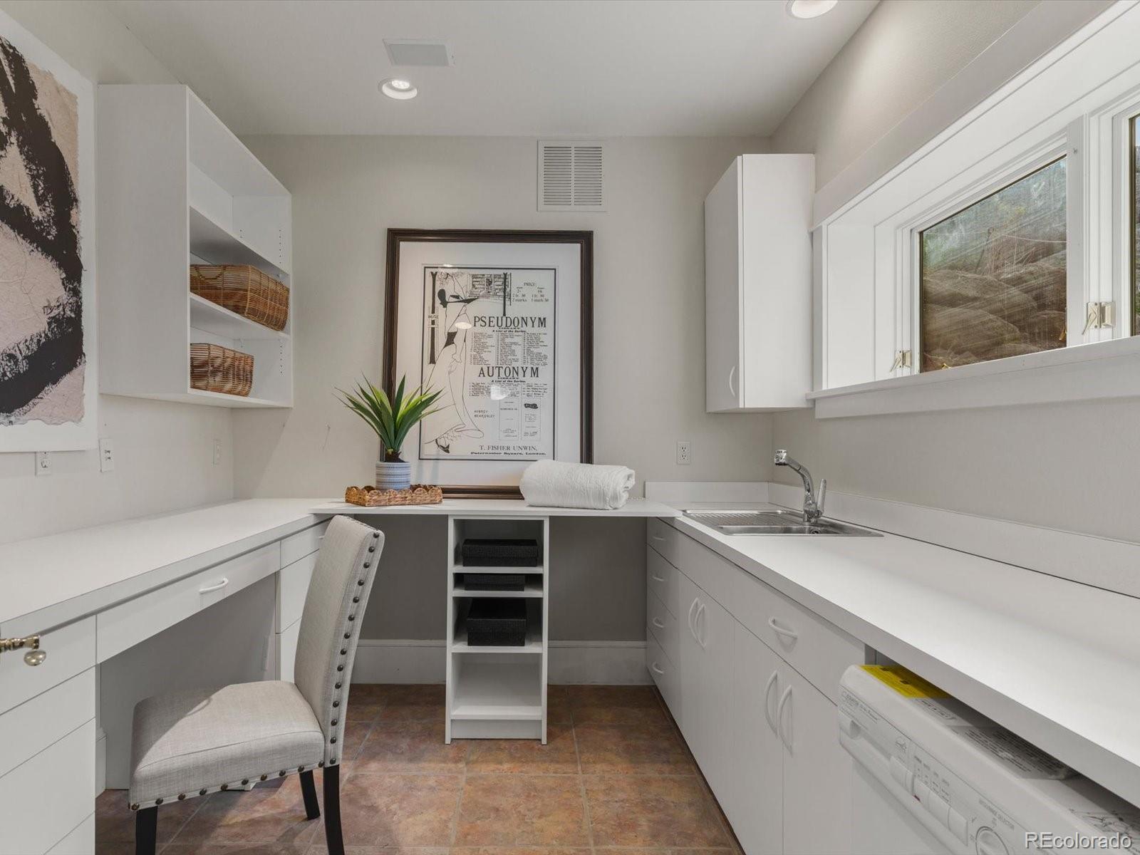 6264 Flagstaff Road Boulder, CO 80302 - Photo 9 of 50 a white kitchen with stainless steel appliances a stove a sink and a refrigerator