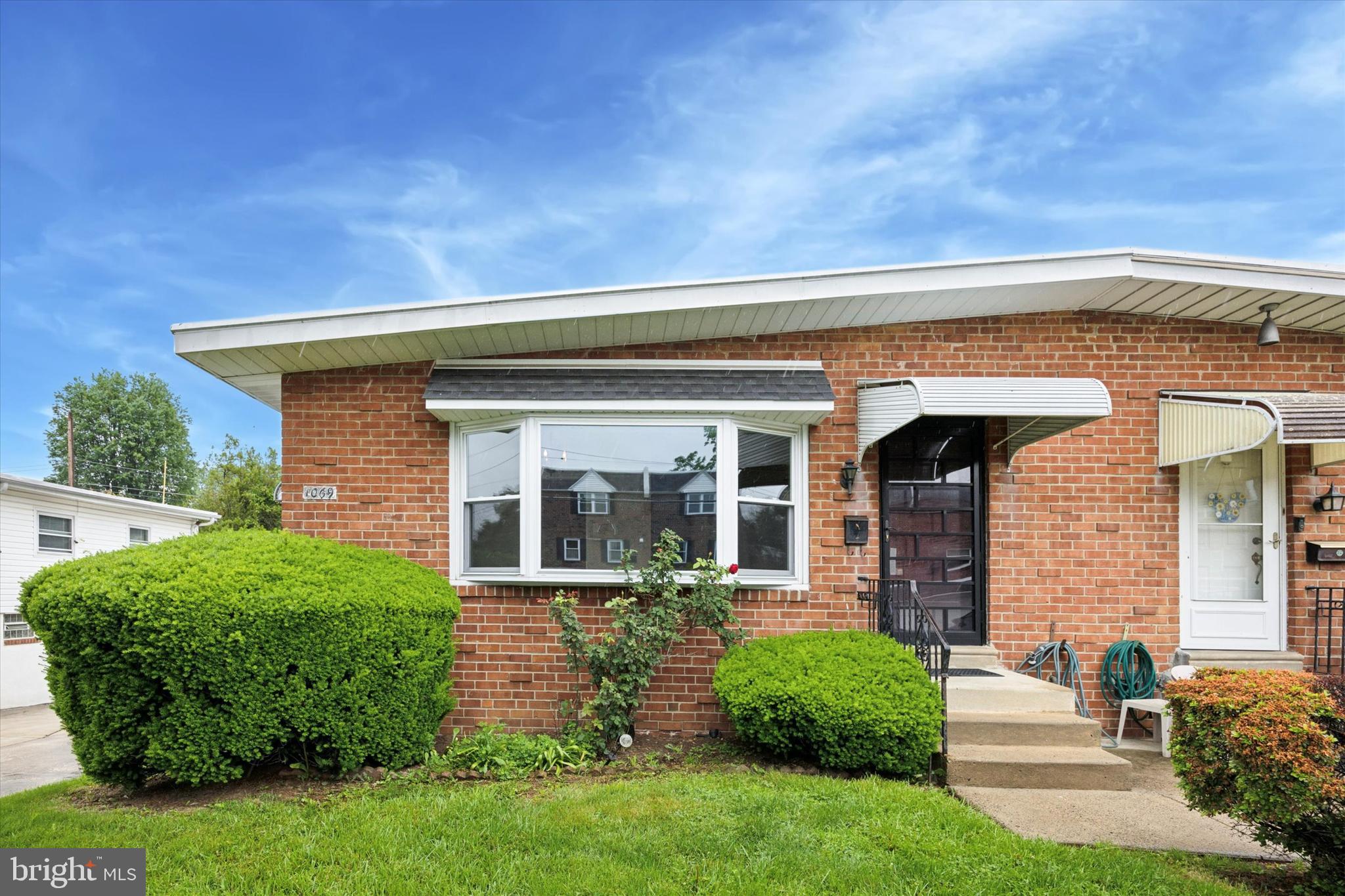 1069 Surrey Road Philadelphia, PA 19115 - Photo 1 of 27 front view of a house with a small yard