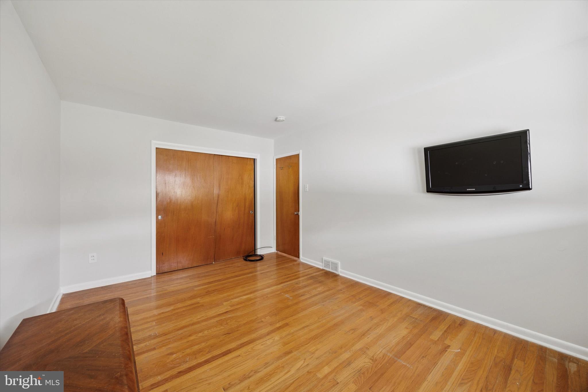1069 Surrey Road Philadelphia, PA 19115 - Photo 14 of 27 a view of an empty room with wooden floor and a window