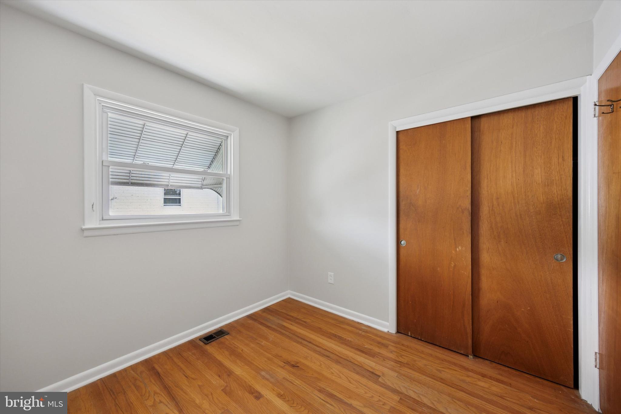 1069 Surrey Road Philadelphia, PA 19115 - Photo 17 of 27 wooden floor in an empty room with a window