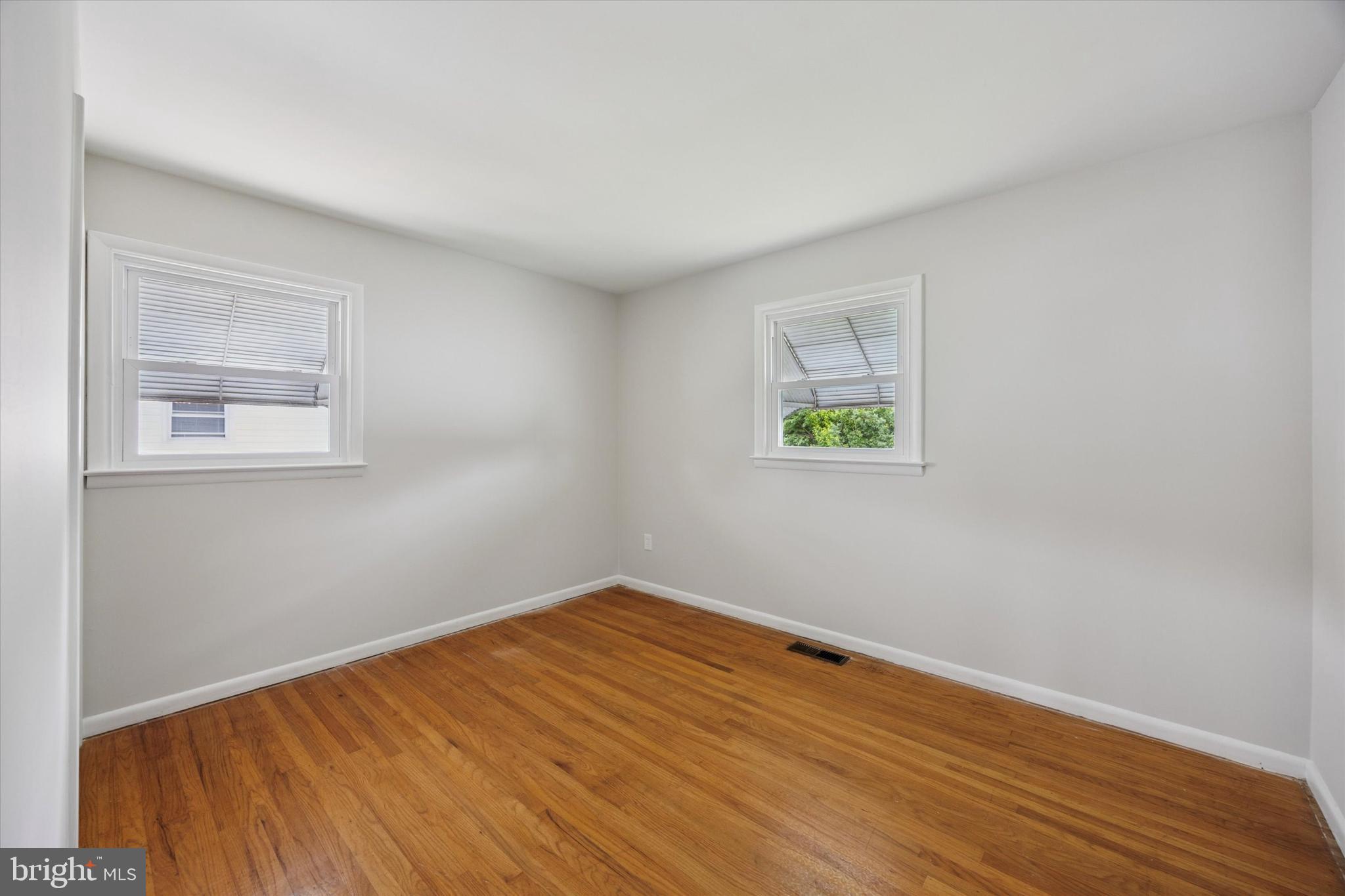 1069 Surrey Road Philadelphia, PA 19115 - Photo 20 of 27 a view of an empty room with wooden floor and a window