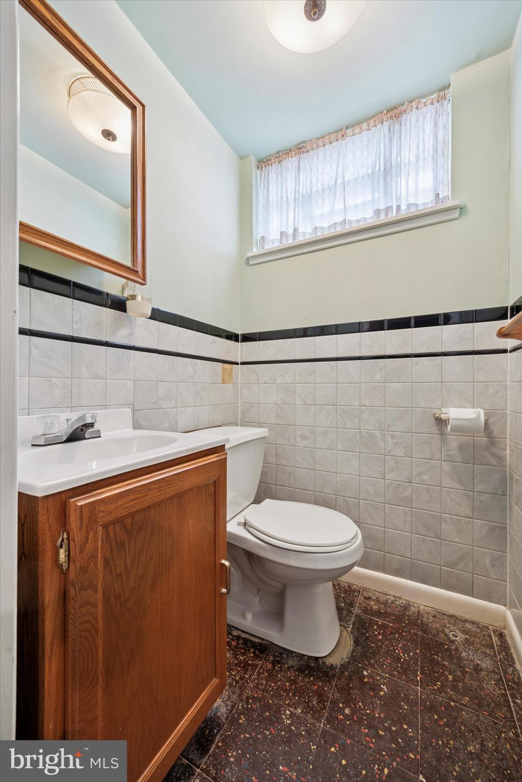 1069 Surrey Road Philadelphia, PA 19115 - Photo 25 of 27 a bathroom with a sink a toilet and a mirror