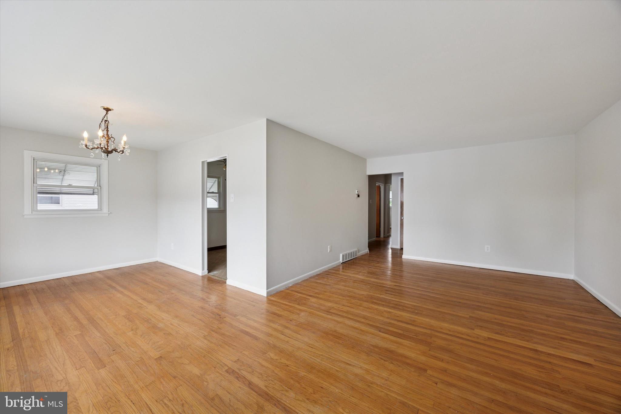 1069 Surrey Road Philadelphia, PA 19115 - Photo 27 of 27 a view of an empty room with wooden floor and a window