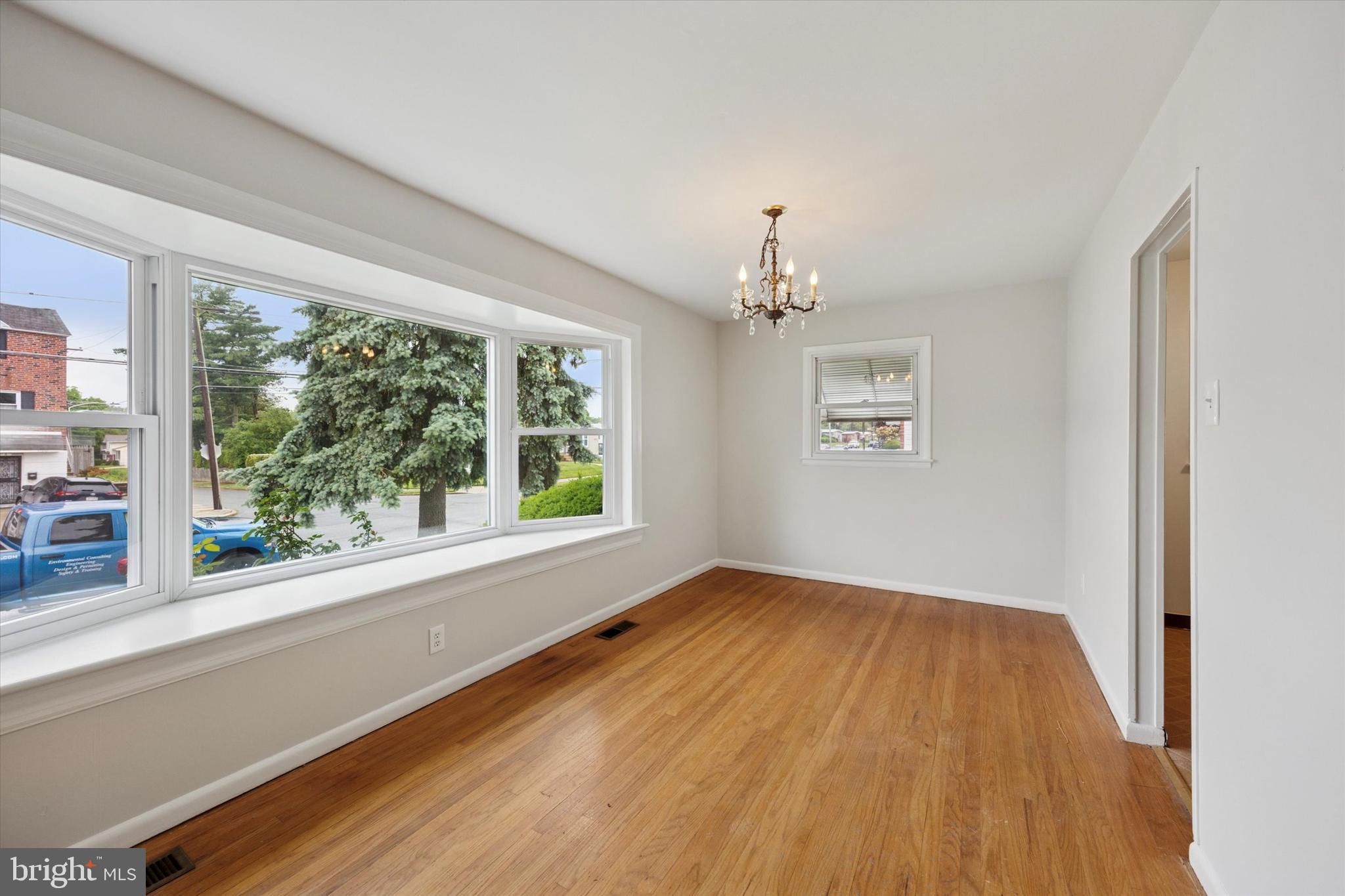 1069 Surrey Road Philadelphia, PA 19115 - Photo 4 of 27 a view of an empty room with wooden floor and a window