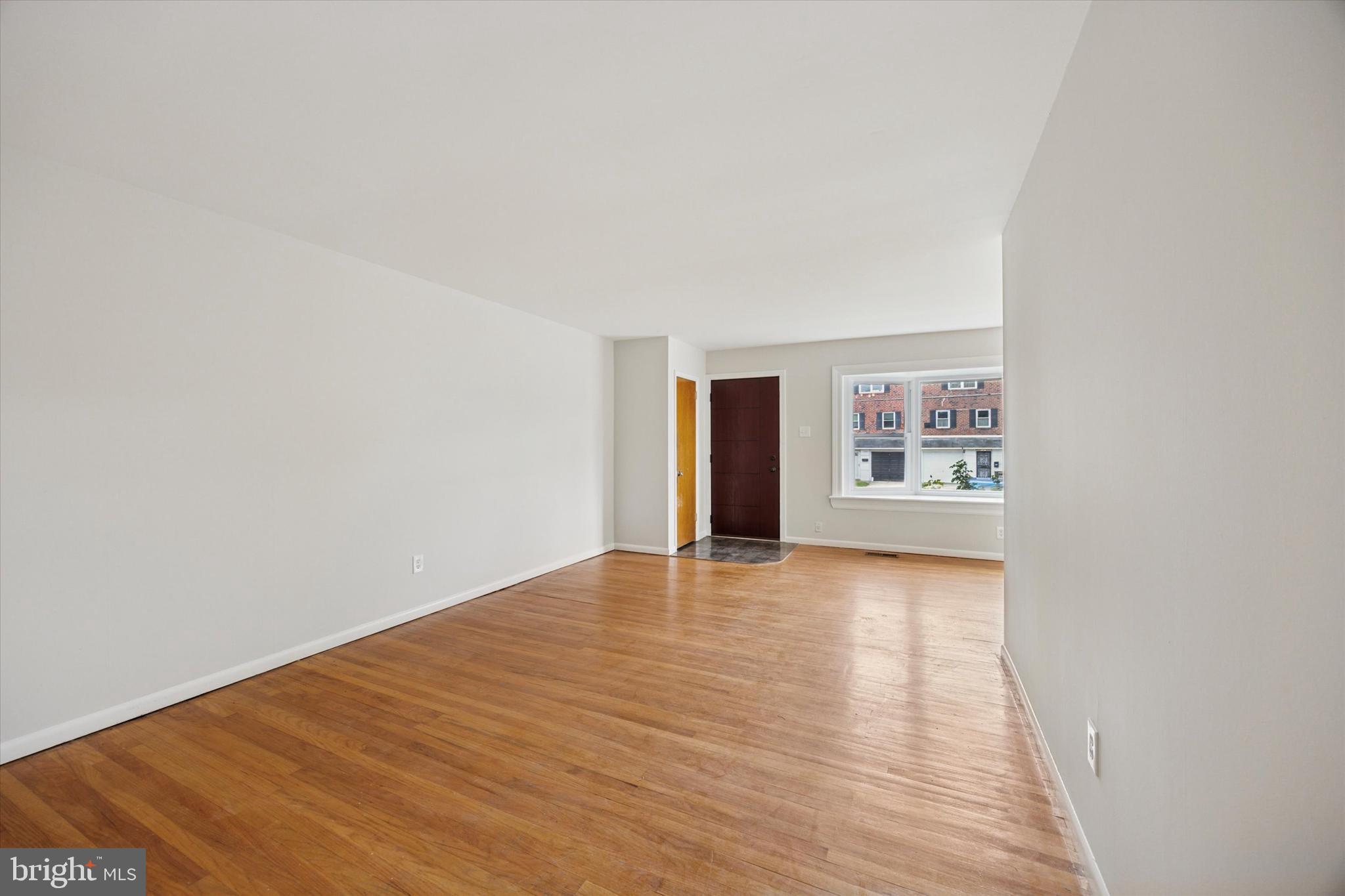 1069 Surrey Road Philadelphia, PA 19115 - Photo 7 of 27 a view of an empty room with wooden floor and a window