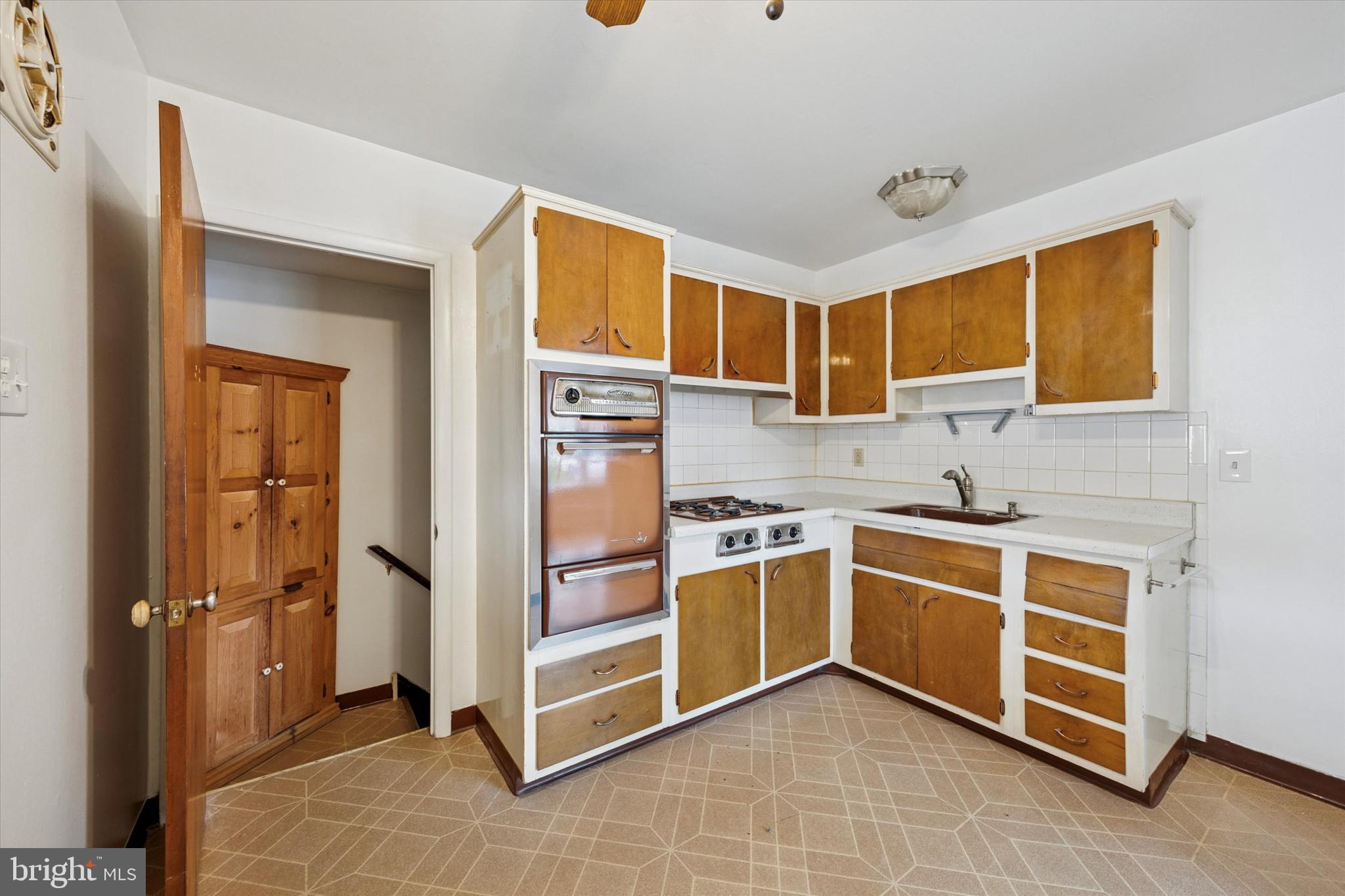 1069 Surrey Road Philadelphia, PA 19115 - Photo 8 of 27 a kitchen with stainless steel appliances granite countertop a stove and a sink