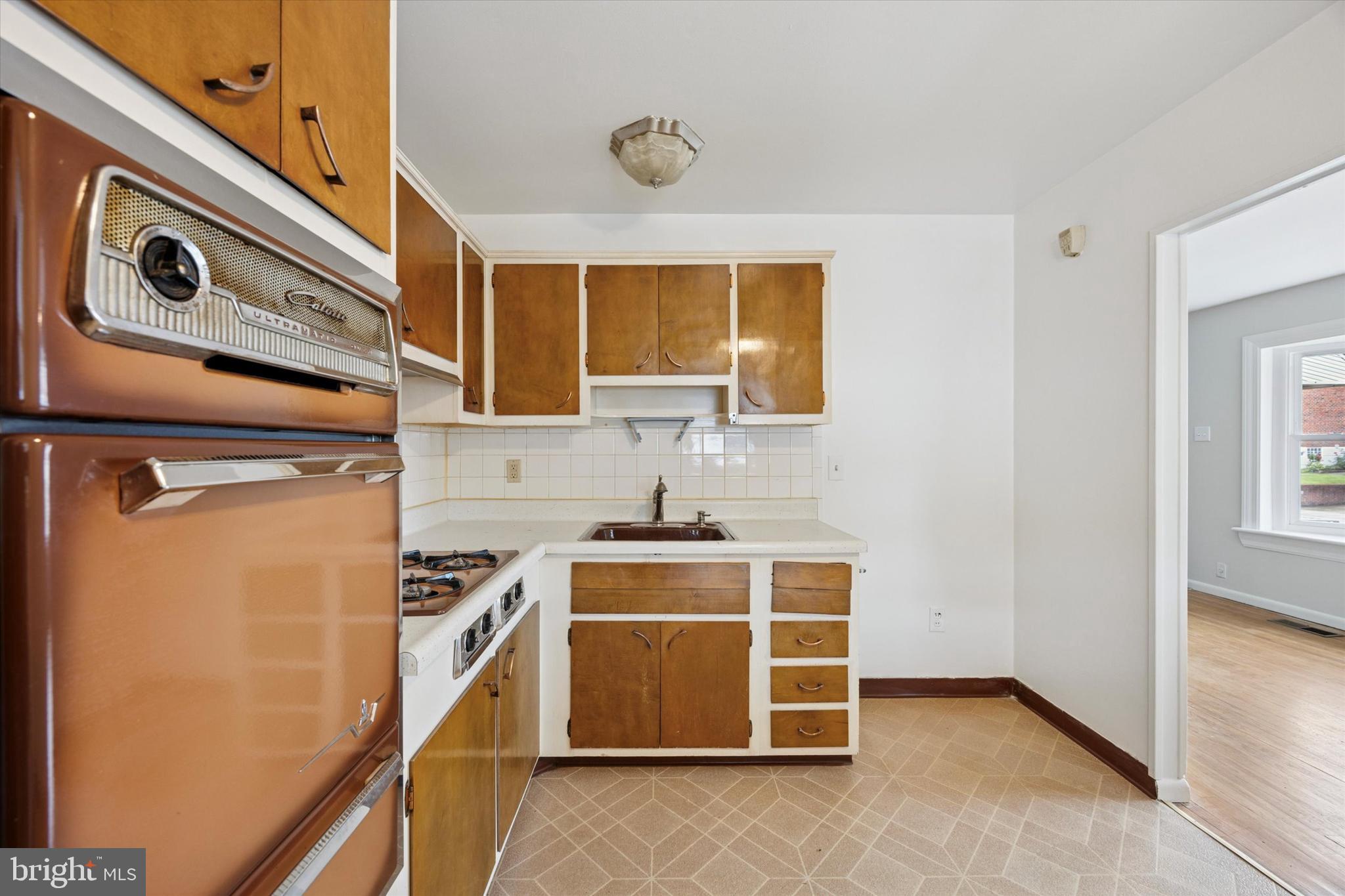 1069 Surrey Road Philadelphia, PA 19115 - Photo 10 of 27 a kitchen with a stove and a microwave