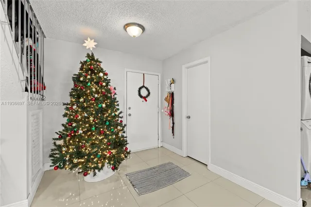 an empty room with a christmas tree