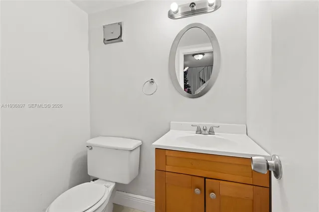 a bathroom with a toilet a sink and mirror