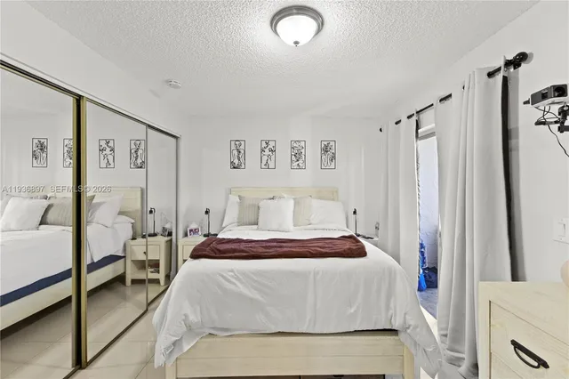 a bedroom with a bed and a mirror