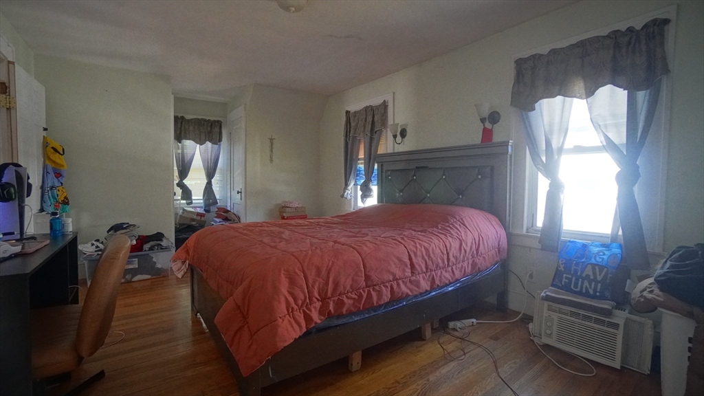 26 Harkness Avenue Springfield, MA 01118 - Photo 16 of 25 a bed sitting in a bedroom next to a window