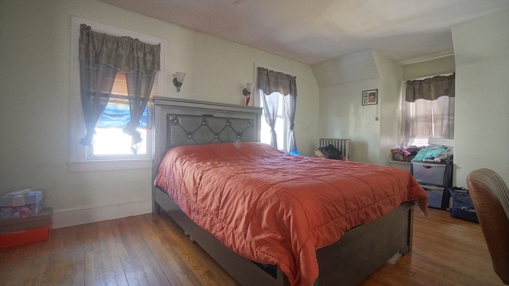 26 Harkness Avenue Springfield, MA 01118 - Photo 17 of 25 a bed sitting in a bedroom next to a window