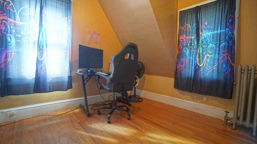 26 Harkness Avenue Springfield, MA 01118 - Photo 18 of 25 a view of a bedroom with furniture and wooden floor