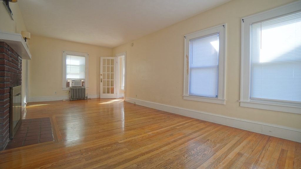 26 Harkness Avenue Springfield, MA 01118 - Photo 5 of 25 a view of empty room with wooden floor and fan