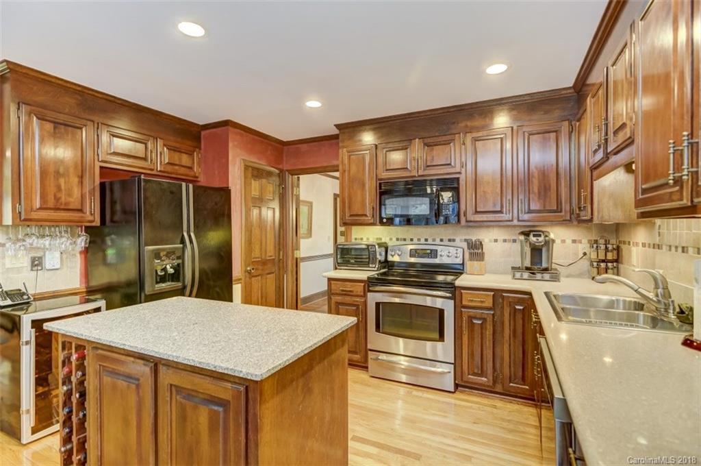 5204 Fowler Farm Road Mint Hill, NC 28227 - Photo 11 of 28 a kitchen with stainless steel appliances granite countertop a sink stove and refrigerator