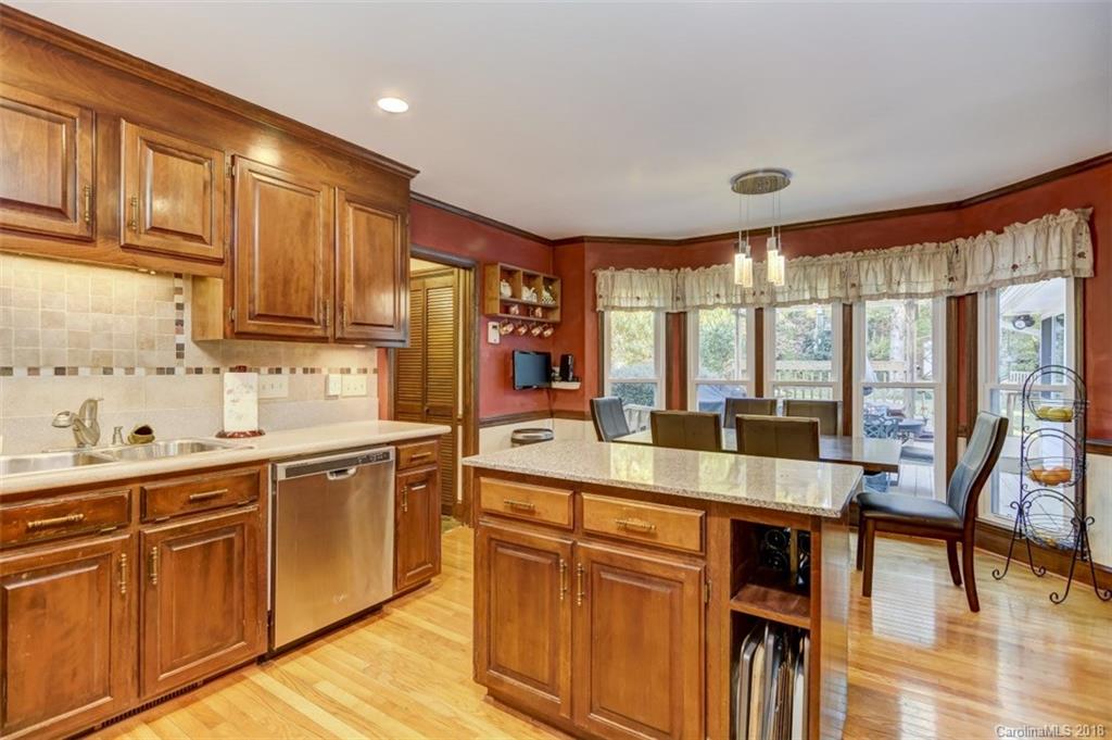 5204 Fowler Farm Road Mint Hill, NC 28227 - Photo 12 of 28 a large kitchen with kitchen island granite countertop a large window and white cabinets