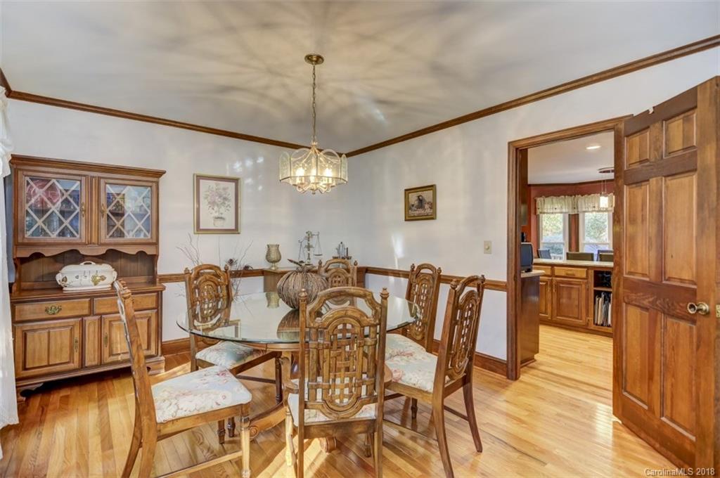 5204 Fowler Farm Road Mint Hill, NC 28227 - Photo 14 of 28 a view of a dining room with furniture a chandelier and wooden floor