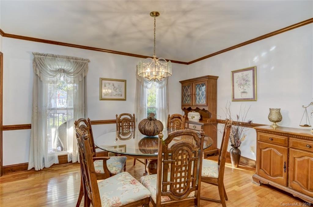 5204 Fowler Farm Road Mint Hill, NC 28227 - Photo 15 of 28 a dining room with furniture a chandelier and wooden floor