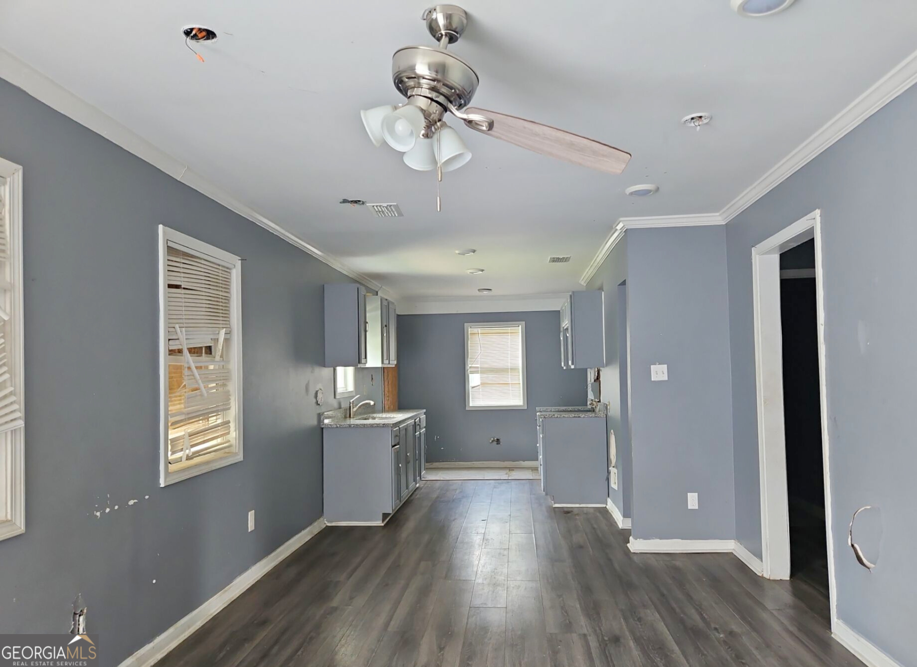117 Dahlia Avenue Northwest Atlanta, GA 30314 - Photo 3 of 10 a view of a kitchen with a dishwasher cabinets and wooden floor