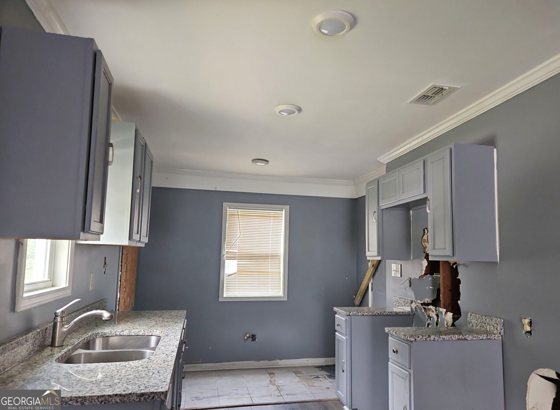 117 Dahlia Avenue Northwest Atlanta, GA 30314 - Photo 4 of 10 a kitchen with kitchen island granite countertop a sink cabinets and window