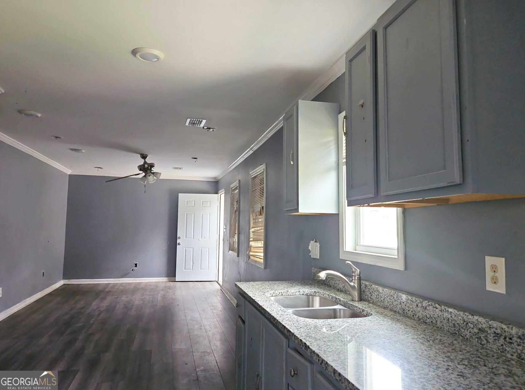 117 Dahlia Avenue Northwest Atlanta, GA 30314 - Photo 7 of 10 a kitchen with granite countertop a sink window and cabinets