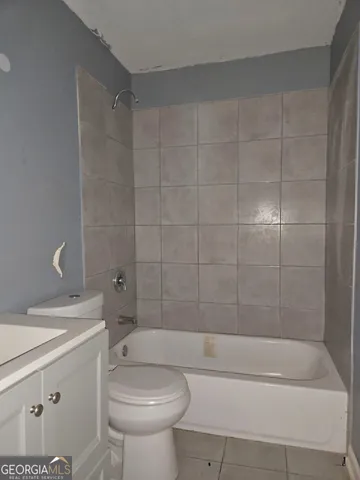 a bathroom with a sink a toilet and bathtub