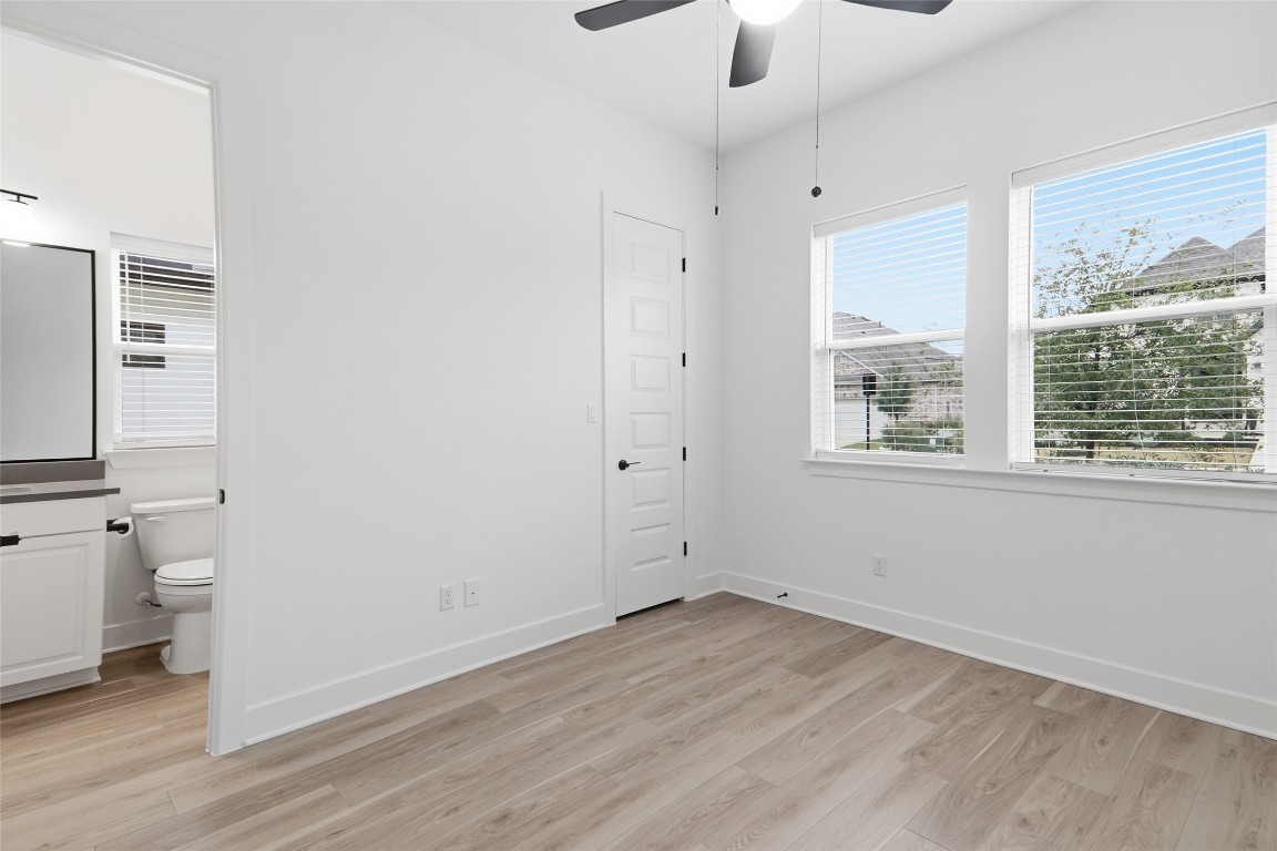 209 Springhouse Road Georgetown, TX 78628 - Photo 22 of 31 Guest bedroom 1 at the front of the house with no carpet and a walk-in closet