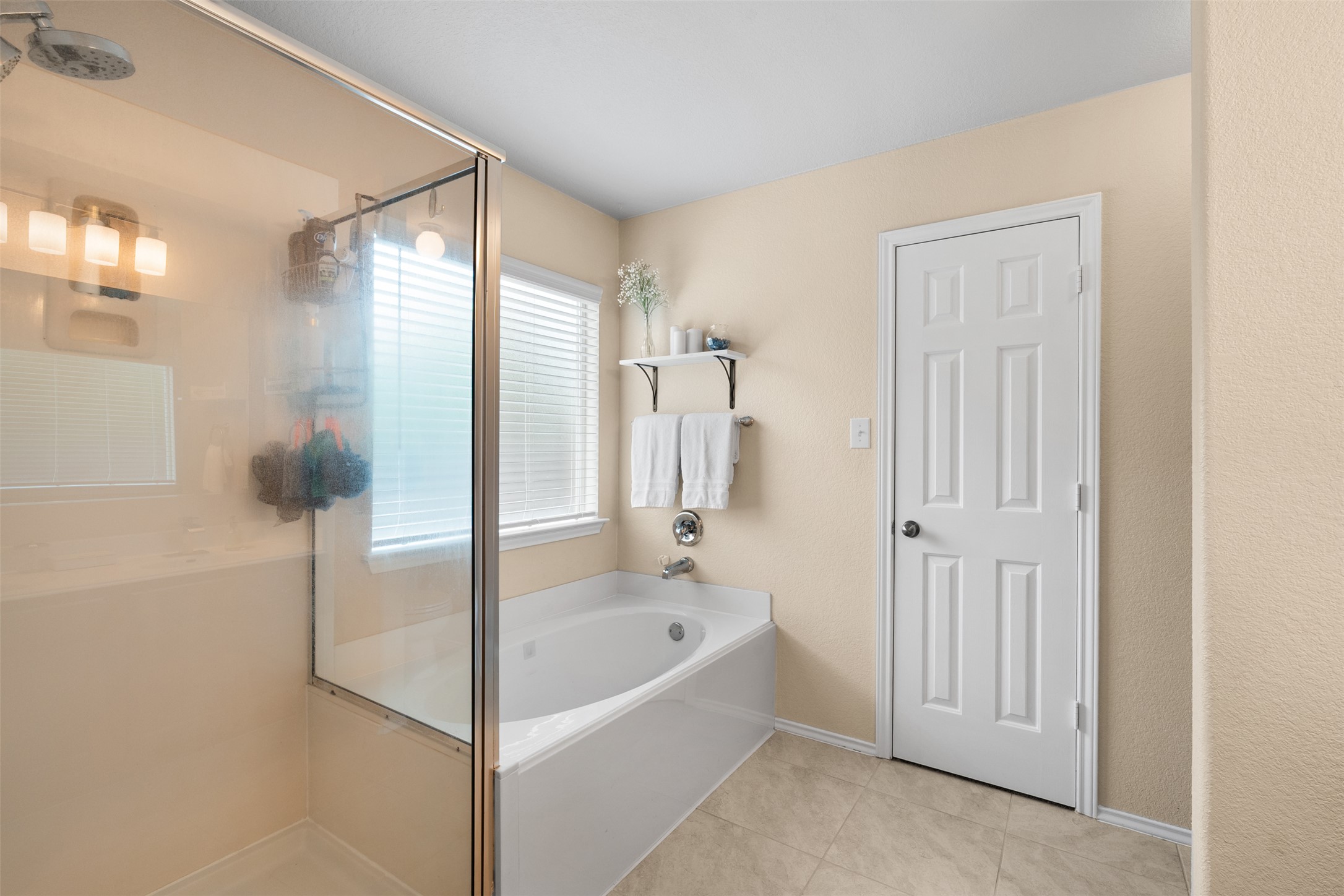 137 Barn Owl Loop Leander, TX 78641 - Photo 23 of 36 a bathroom with a bathtub and a shower
