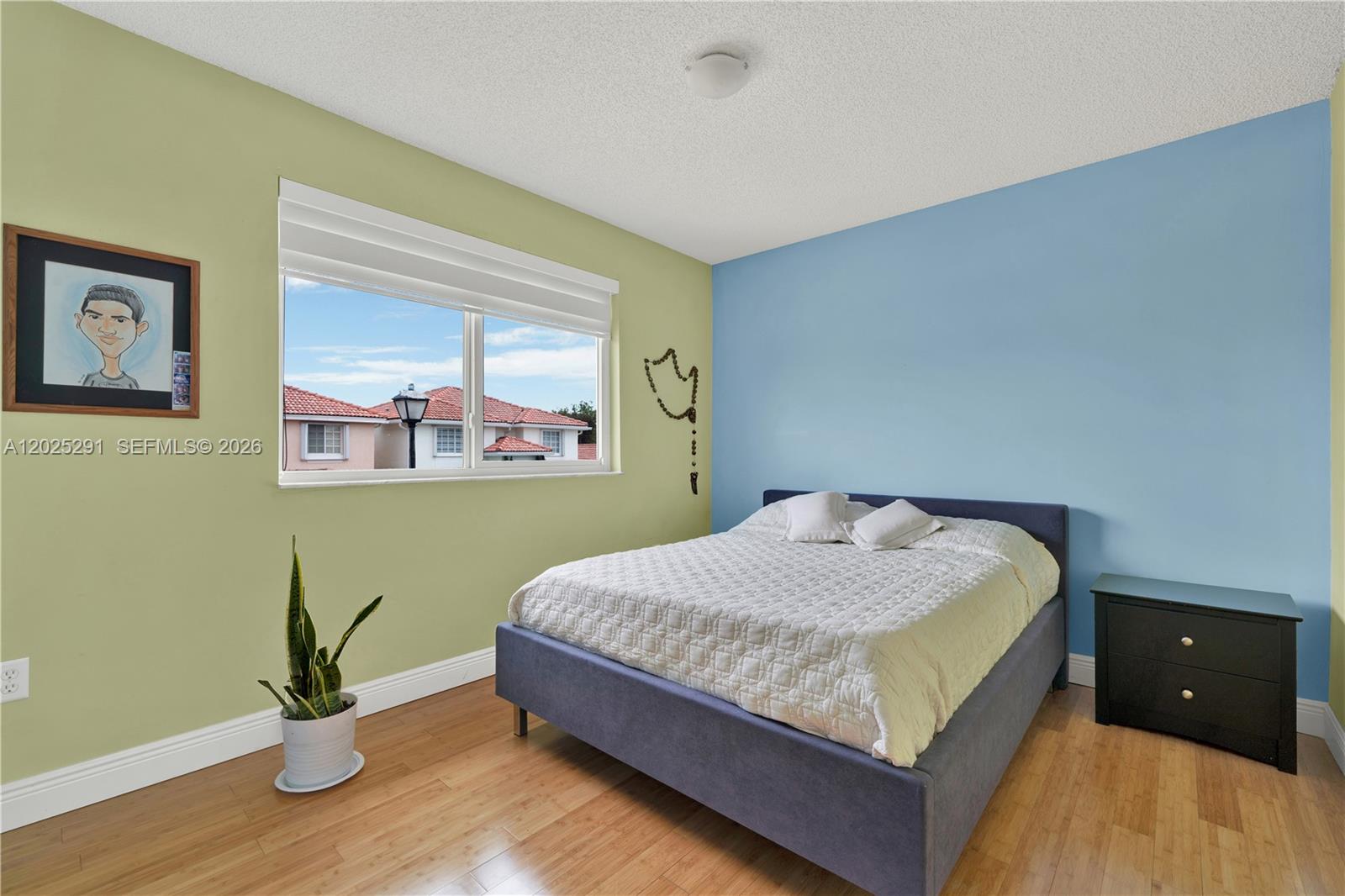 10006 Southwest 162nd Path Miami, FL 33196 - Photo 23 of 40 a bed sitting in a bedroom next to a window