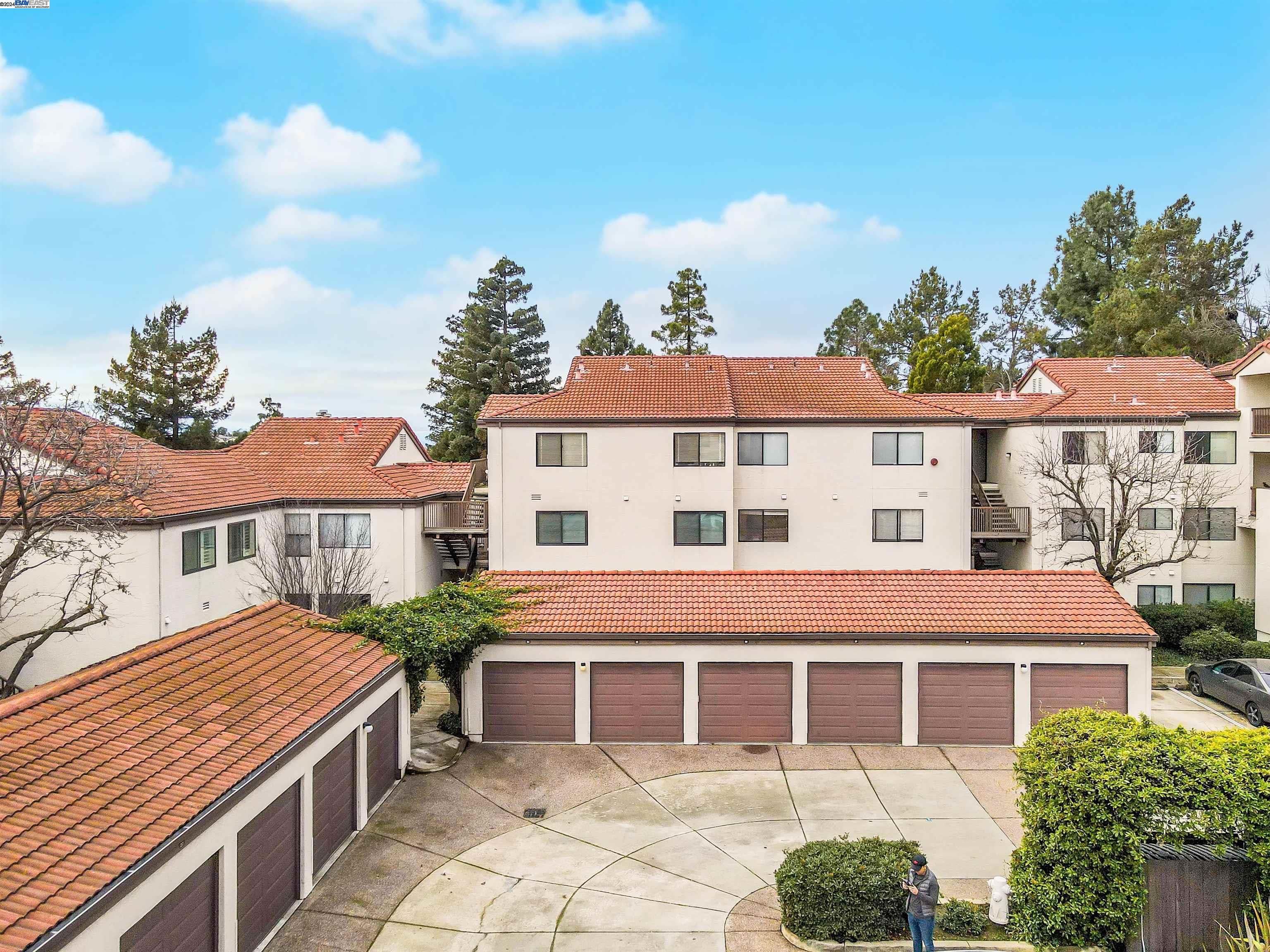 a view of a house with a yard and potted plants