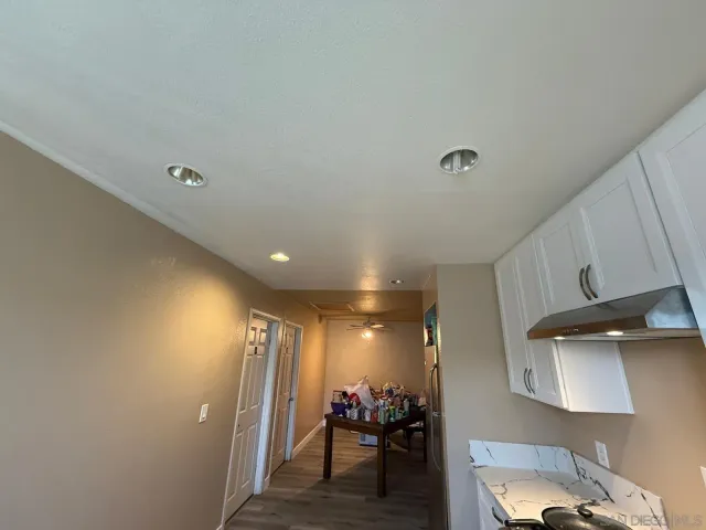 a view of a hallway and a livingroom with furniture