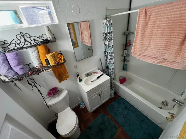 a white bath tub sitting next to a white toilet and sink