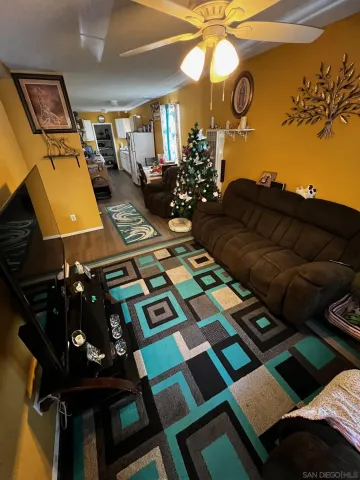 a picture of a living room with a rug and a fireplace