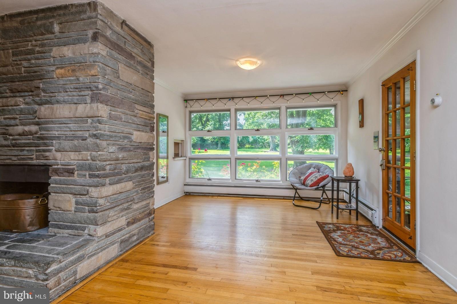 536 Rosedale Road Princeton, NJ 08540 - Photo 11 of 34 a living room with furniture floor to ceiling window and a fireplace